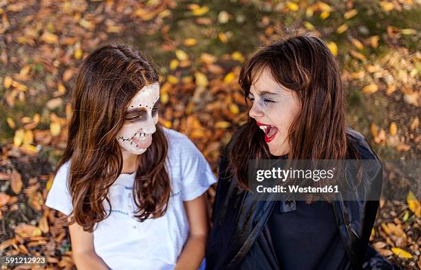 two masquerade girls at halloween - girl 11 12 laughing close up foto e immagini stock