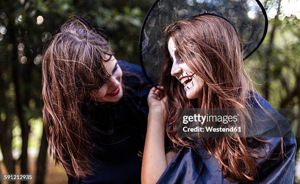 portrait of two masquerade girls having fun at halloween - girl 11 12 laughing close up foto e immagini stock