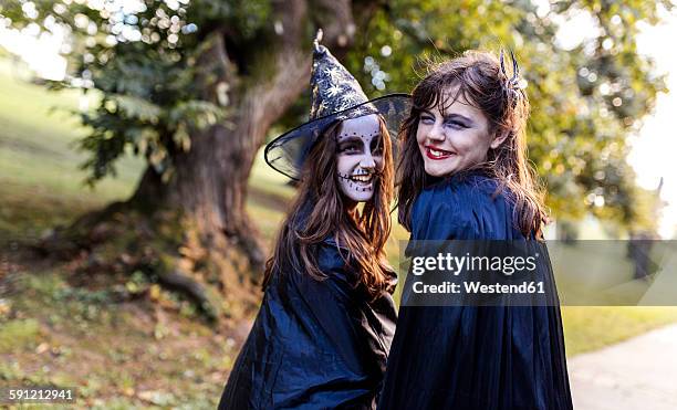 portrait of two masquerade girls at halloween - girl 11 12 laughing close up foto e immagini stock