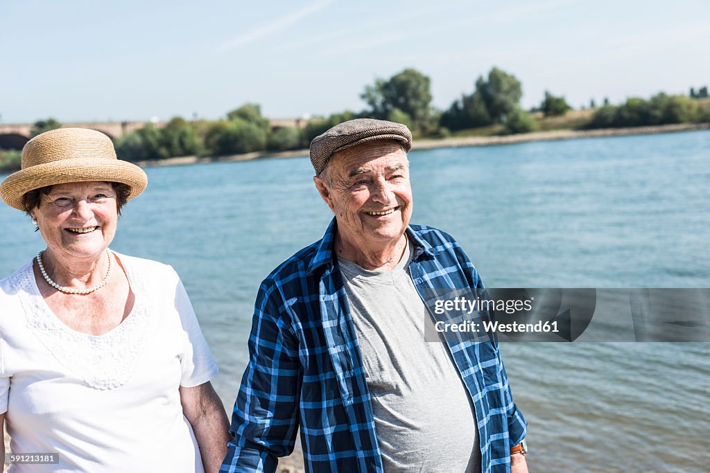 Germany, Ludwigshafen, portrait of happy senior couple at riverside
