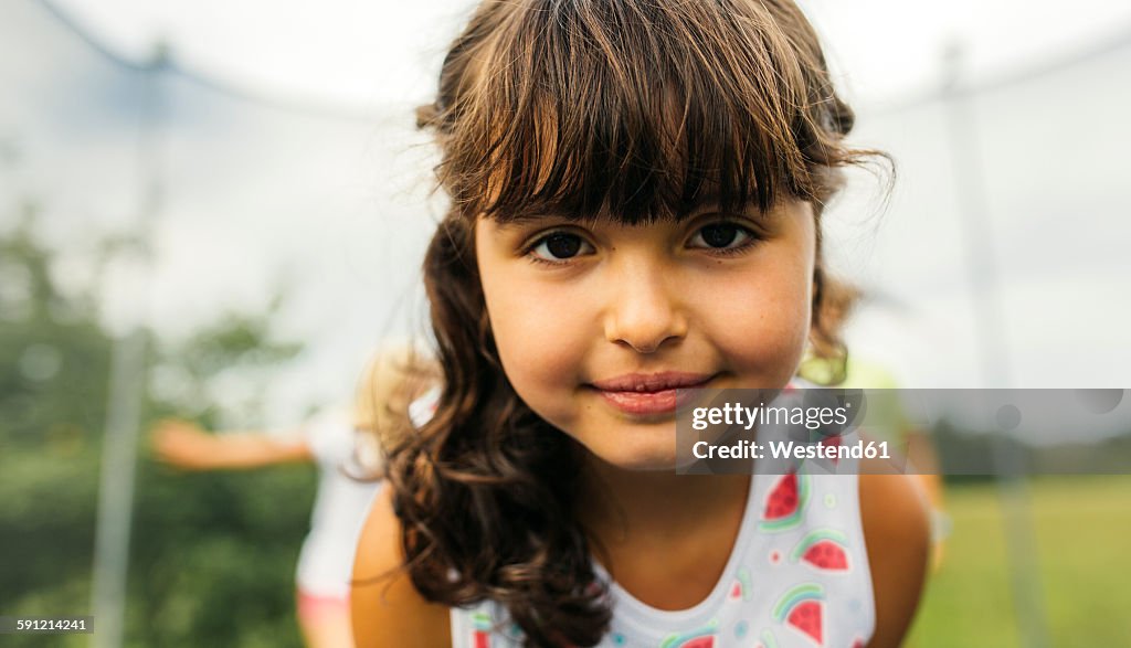 Portrait of brunette girl on trampoline