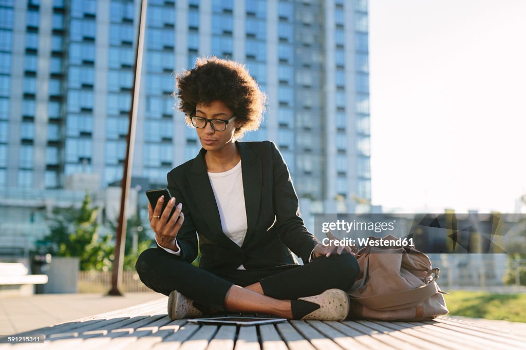 USA, New York City, portrait businesswoman looking at smartphone