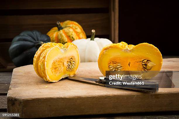 different sorts of mini squashes with sliced jack be little in the foreground - jack be little squash ストックフォトと画像