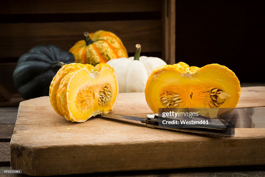 Different sorts of mini squashes with sliced Jack be Little in the foreground