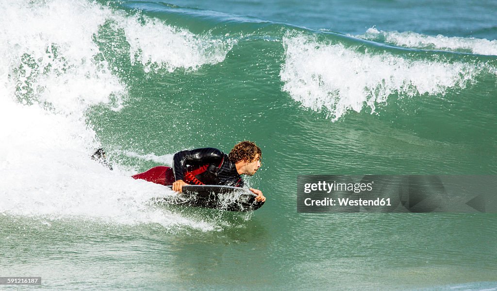 Spain, Asturias, Colunga, body board rider on the waves