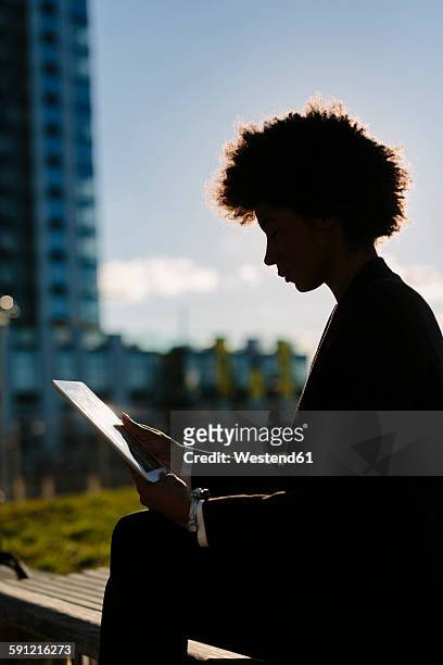 usa, new york city, silhouette of businesswoman looking at digital tablet - high contrast stock pictures, royalty-free photos & images