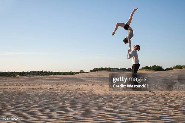 netherlands, acrobat couple performing hand to hand stands - acrobatic activity stock pictures, royalty-free photos & images