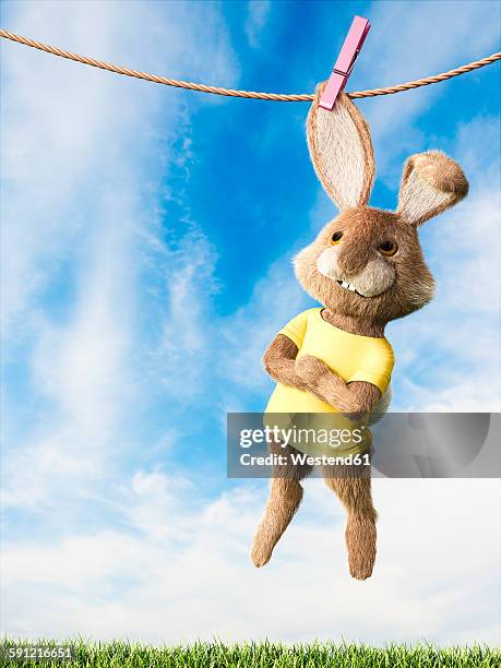 easter bunny hanging on clothes line with arms crossed - easter bunny costume stock illustrations