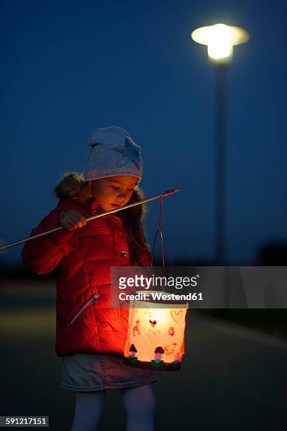 portrait of little girl with lighted paper lantern on st. martin's day at twilight - paper lanterns stock pictures, royalty-free photos & images