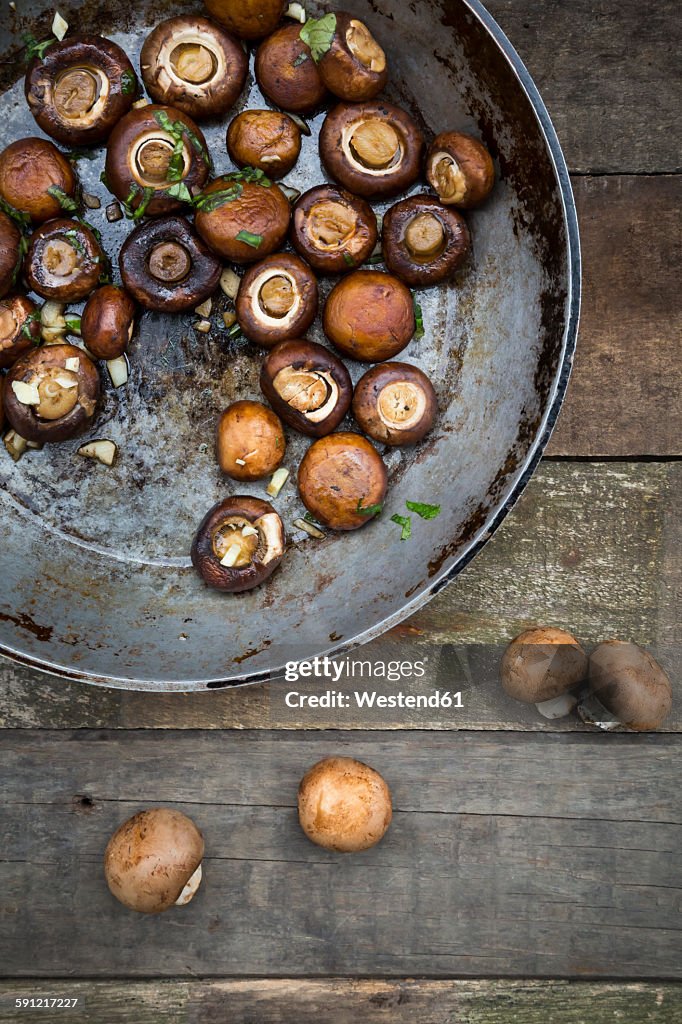 Crimini mushrooms with garlic and basil in pan, braised