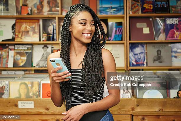 laughing college student with phone - african woman shopping photos et images de collection