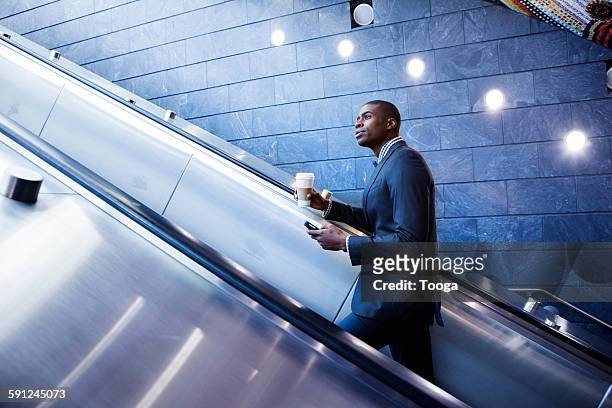 professional riding up escalator - escalator side view stock pictures, royalty-free photos & images