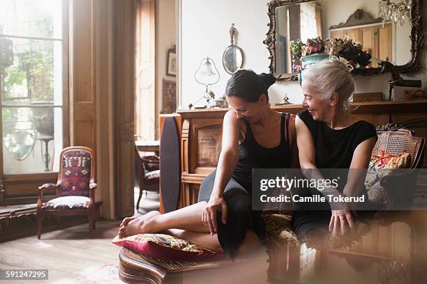 two fashionable women sharing time and smiling - elegance family stock pictures, royalty-free photos & images