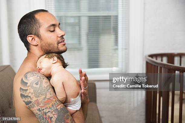 baby boy resting on father's chest - man wearing diaper stock pictures, royalty-free photos & images