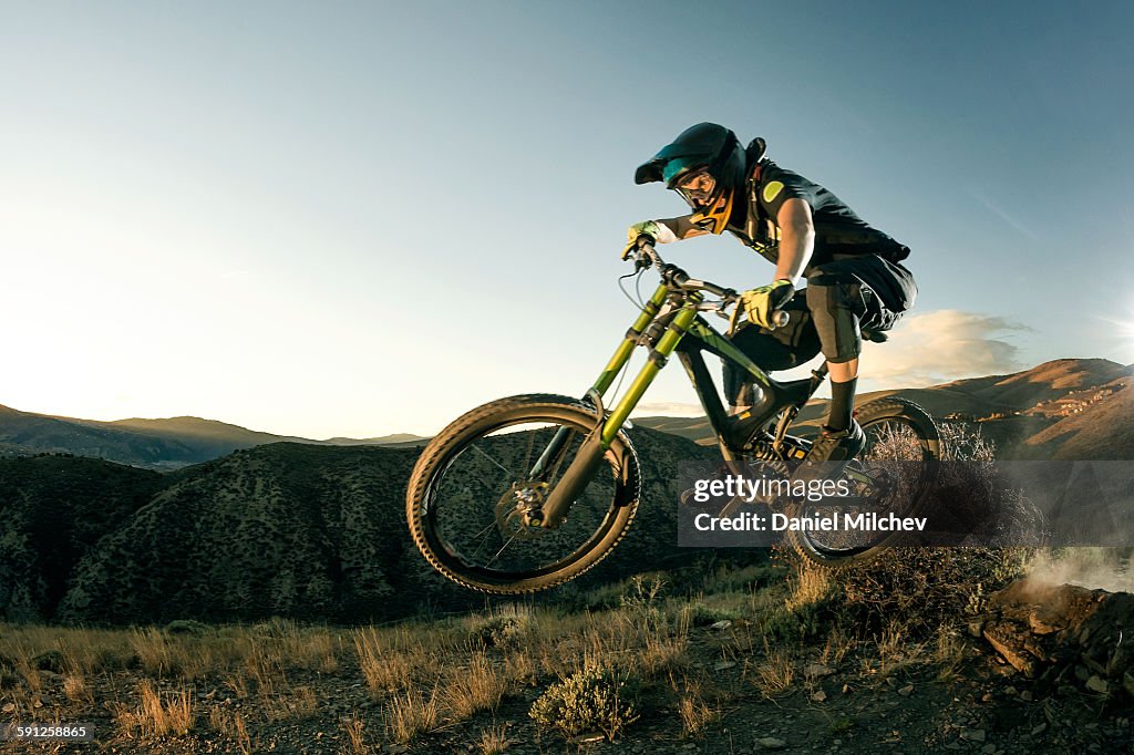Female biker jumping on her mountain bike.