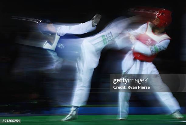 Carlos Ruben Navarro Valdez of Mexico kicks Yousef Shriha of Libya during the Taekwondo Men's -58kg Round One contest on Day 11 of the Rio 2016...