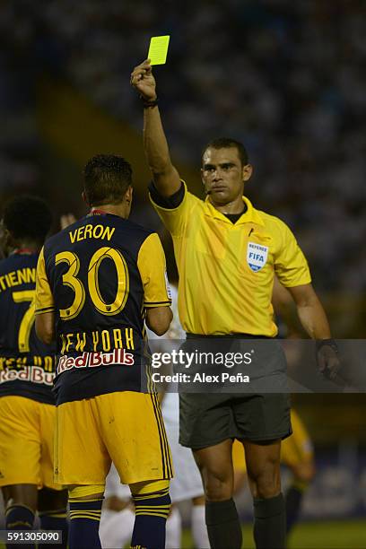 Referee Oscar Moncada shows a yellow card to Gonzalo Veron of Red Bulls during a match between Red Bulls and Alianza as part of Liga de Campeones...