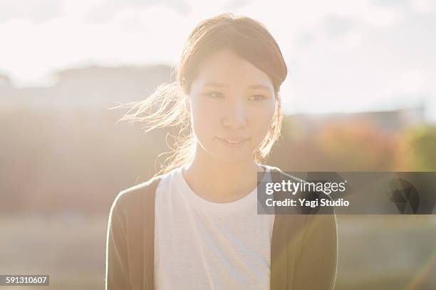 woman standing and smiling in the city - överexponerad bildbanksfoton och bilder