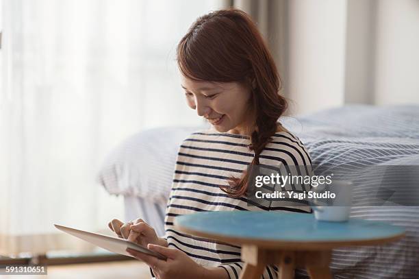 woman relaxing and using the digital tablet - woman smiling facing down stock pictures, royalty-free photos & images