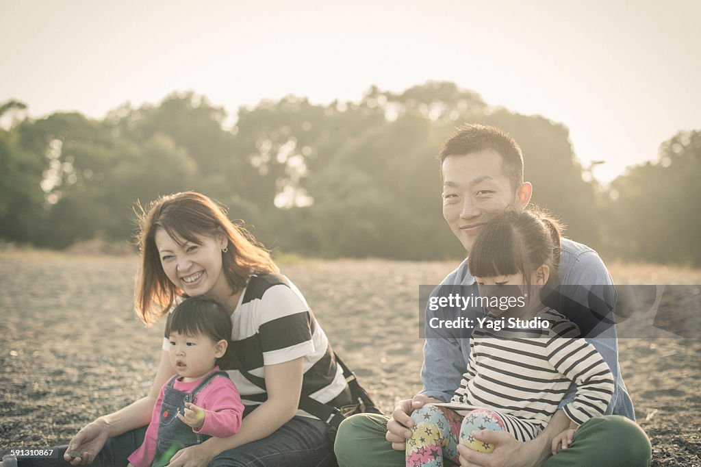 Family enjoying in front of the lake shore