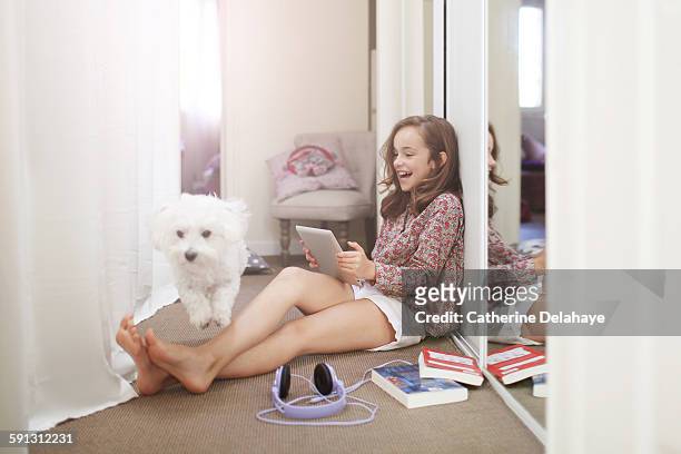 a 10 years old girl with her dog and a tablet - girl 10 years old happy stock-fotos und bilder