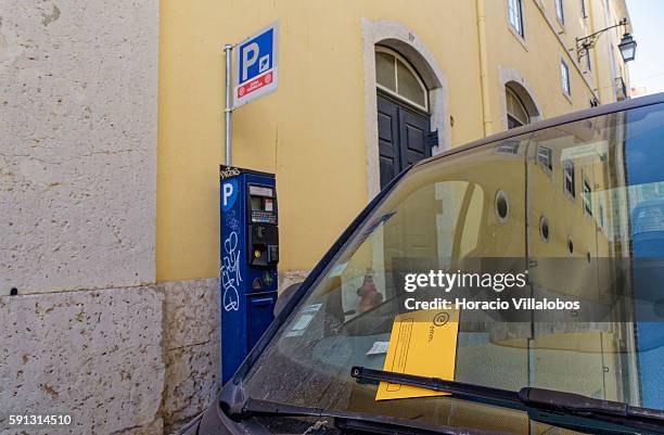 Parking ticket on the windshield of a car parked in front of a parking meter in Rua Serpa Pinto, Chiado neighborhood, on August 16, 2016 in Lisbon,...