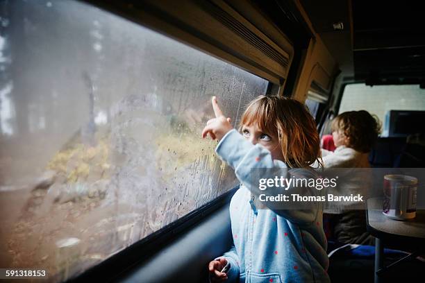 children drawing on windows inside camper van - autofahrt stock-fotos und bilder