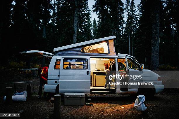 Boy looking out side door of camper at night