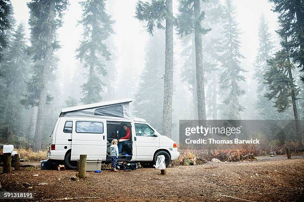 father in camper in discussion with daughter - caravaning stock-fotos und bilder