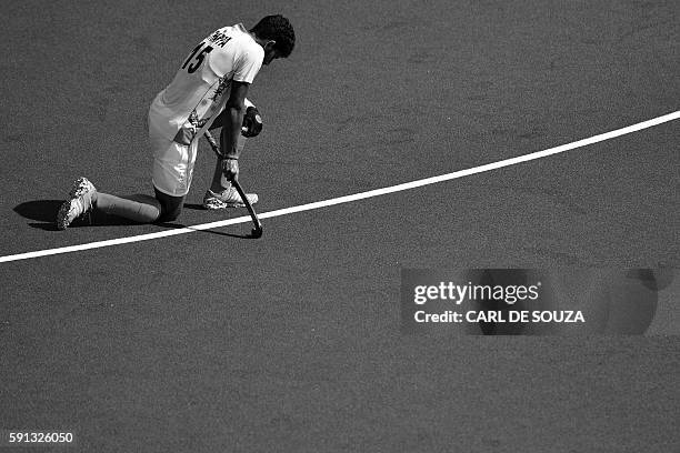 India's Uthappa Sannuvanda kneels on the pitch at the end of the men's quarterfinal field hockey Belgium vs India match of the Rio 2016 Olympics...