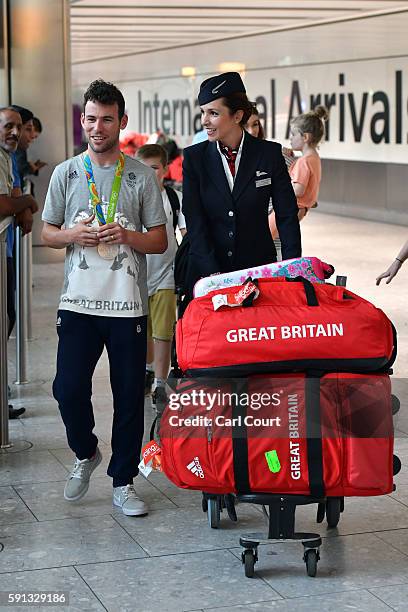 Great Britain's Mark Cavendish walks through the arrivals hall after arriving on a British Airways flight from Rio de Janeiro to London Heathrow...