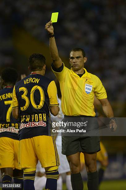 Referee Oscar Moncada shows a yellow card to Gonzalo Veron of Red Bulls during a match between Red Bulls and Alianza as part of Liga de Campeones...