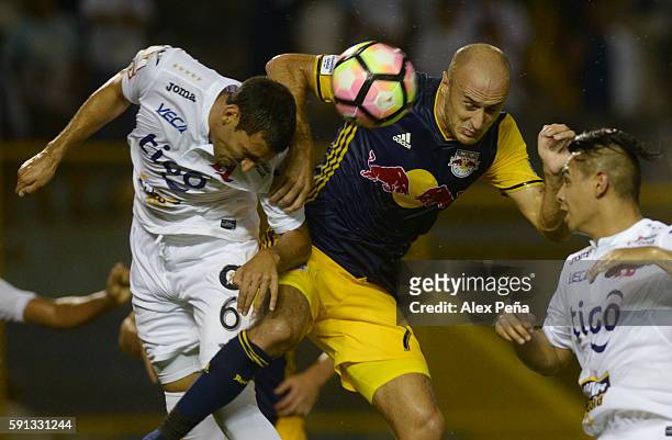 Aurelien Collin of Red Bulls fights for the ball with Fabricio Silva and Alexander Larin of Alianza during a match between Red Bulls and Alianza as...