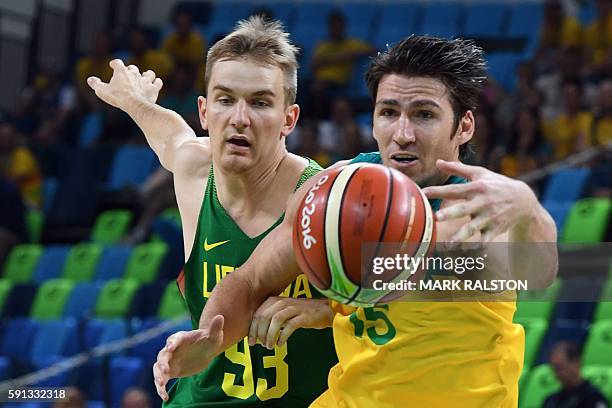 Australia's guard Damian Martin and Lithuania's point guard Vaidas Kariniauskas go for the ball during a Men's quarterfinal basketball match between...