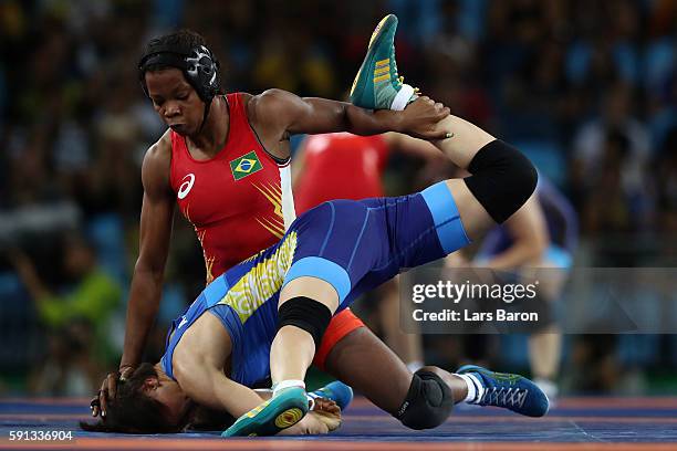 Joice Souza da Silva of Brazil competes against Aisuluu Tynybekova of Kyrgyzstan during a Women's Freestyle 58kg 1/8 Final bout on Day 12 of the Rio...