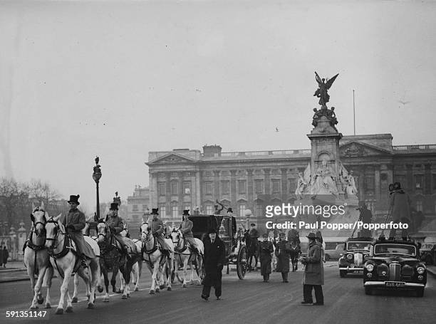 Soldiers of the Household Cavalry on horseback along with drummers and guardsmen of the Grenadier Guards escort a State landau carriage along the...