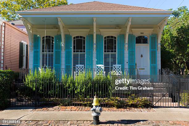 Traditional bright color clapboard cottage house in the Garden District of New Orleans, Louisiana, USA