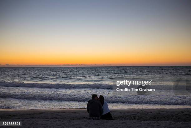 Romantic young couple watching the sunset on Captiva Island in Florida, USA