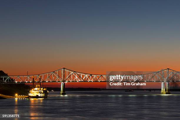 Nighttime scene of illuminated iron cantilever Natchez - Vidalia Bridge road bridge across the Mississippi River in Louisiana, USA