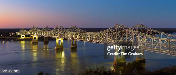 Nighttime scene of illuminated iron cantilever Natchez - Vidalia Bridge road bridge across the Mississippi River in Louisiana, USA