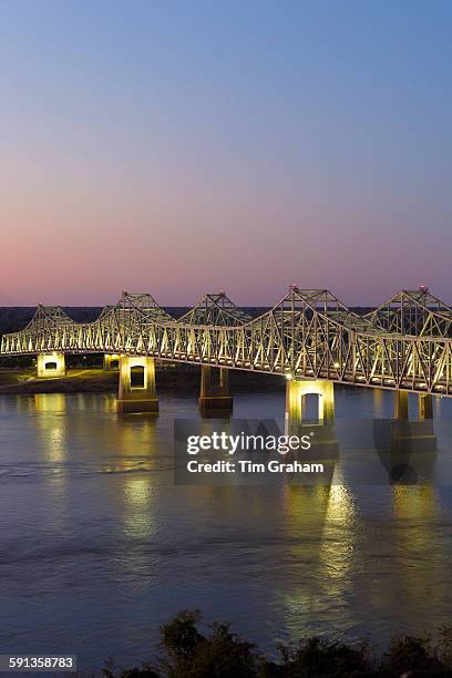 Nighttime scene of illuminated iron cantilever Natchez - Vidalia Bridge road bridge across the Mississippi River in Louisiana, USA