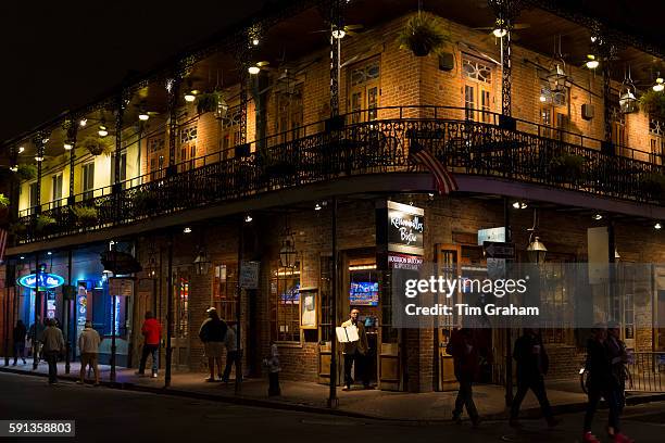 Street scene and Retrouvailles Bistro in famous Bourbon Street in French Quarter of New Orleans, USA