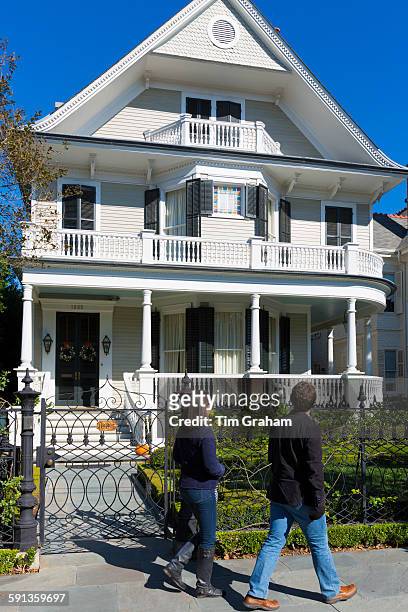 Tourists tour grand mansion houses in the Garden District of New Orleans, Louisiana, USA