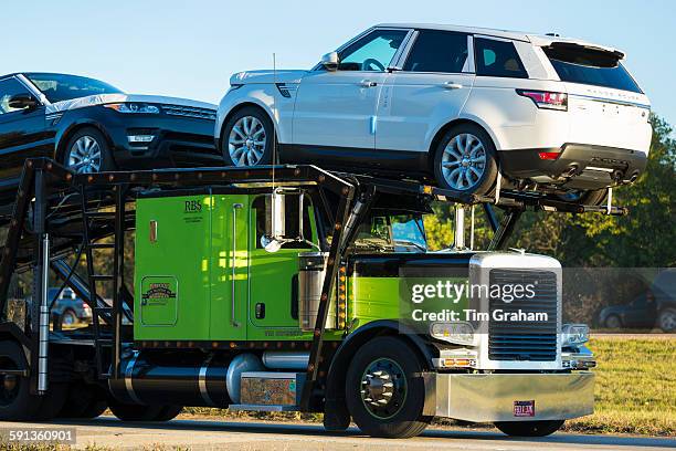 Shiny American Freightliner truck transporting Range Rover autos - car transporter - on route Interstate 10, Louisiana USA