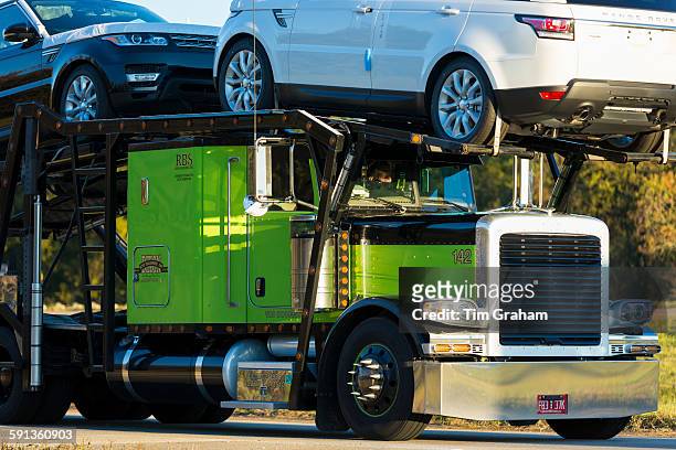 Shiny American Freightliner truck transporting Range Rover autos - car transporter - on route Interstate 10, Louisiana USA