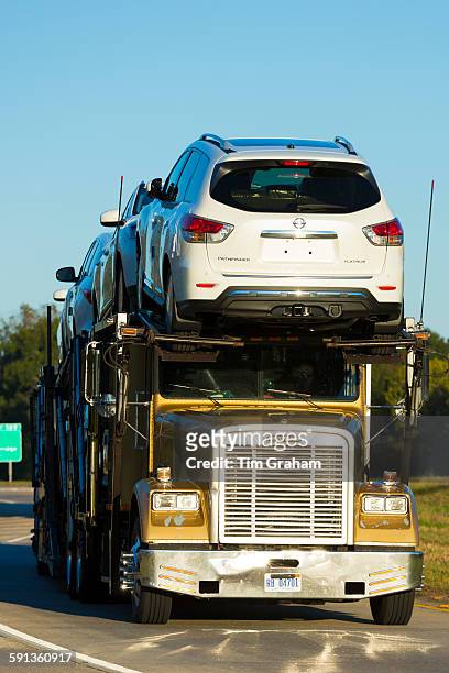 Typical shiny American Freightliner truck transporting new automobiles - car transporter - on route Interstate 10, Louisiana USA