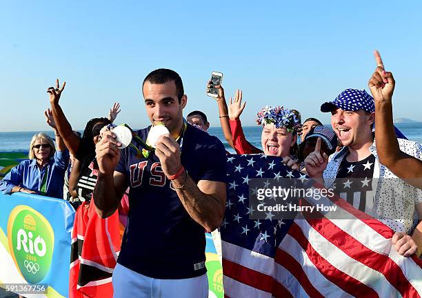 Gymnast, Danell Leyva of the United States poses with his two silver medals on the Today show set on Copacabana Beach on August 17, 2016 in Rio de...