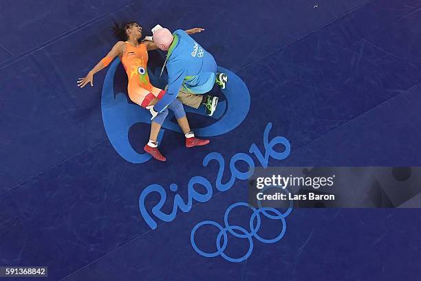 An injured Vinesh Vinesh of India is treated during a Women's Freestyle 48kg Quarterfinal bout against Yanan Sun of China on Day 12 of the Rio 2016...
