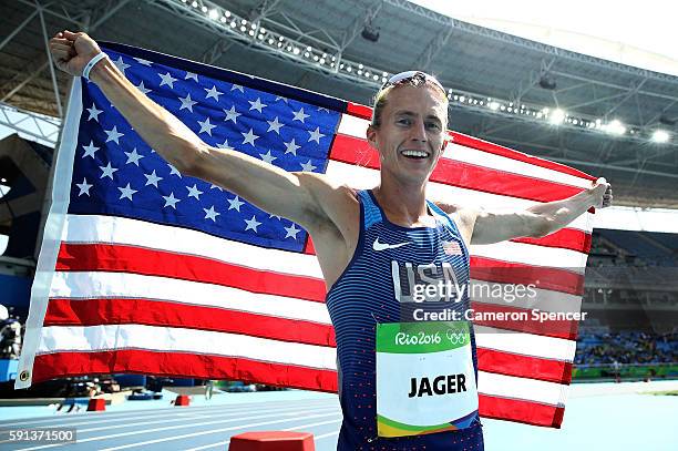 Evan Jager of the United States celebrates with the American flag after winning the silver medal in the Men's 3000m Steeplechase Final on Day 12 of...