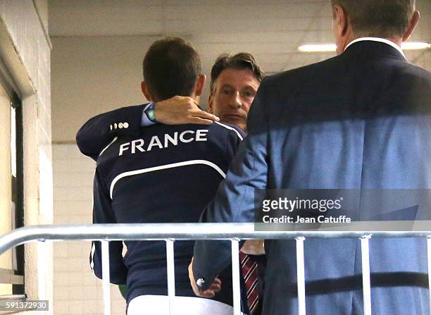 Silver medalist in Pole Vault Renaud Lavillenie of France is consoled by IAAF President Sebastian Coe and Sergey Bubka following the medal ceremony...
